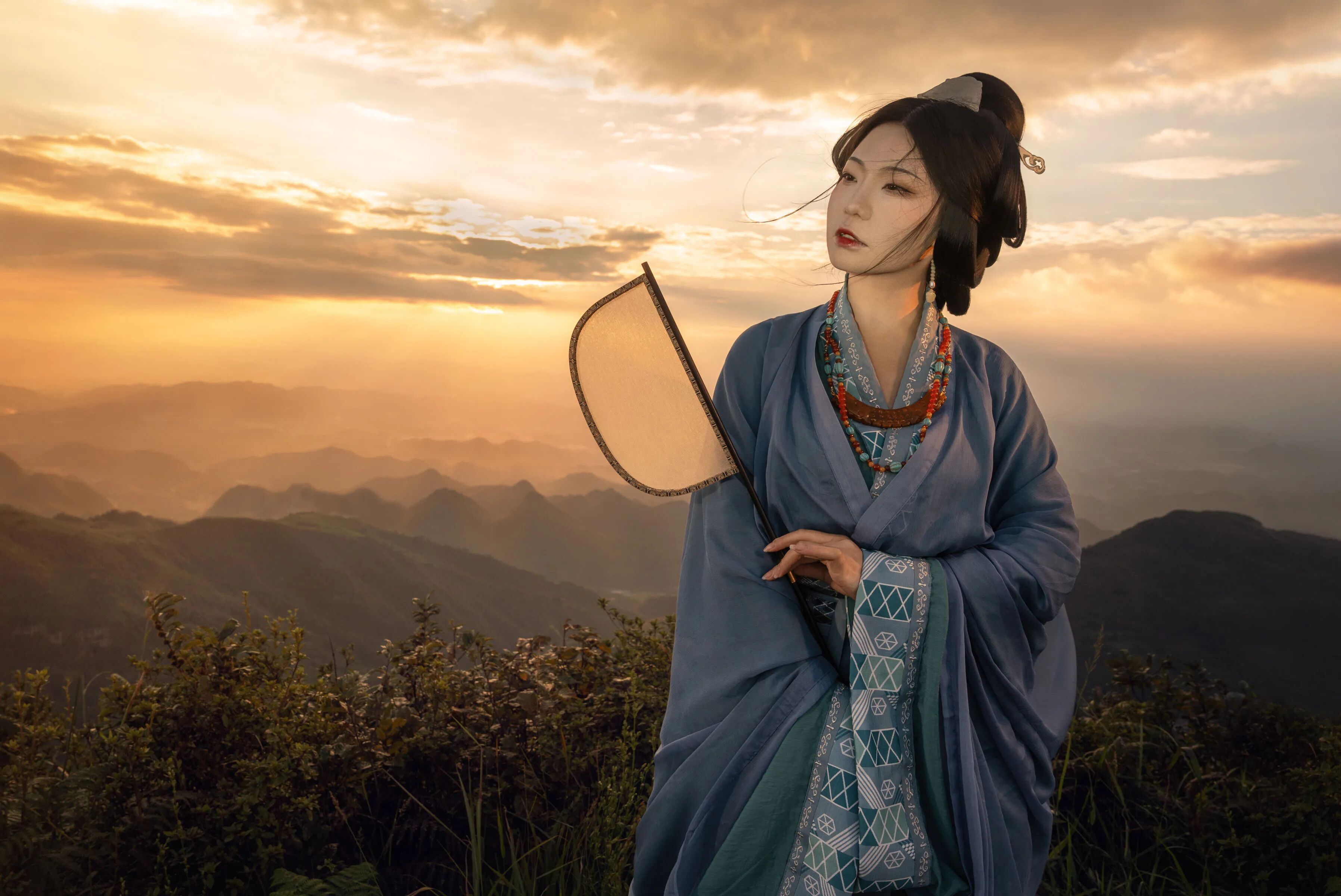 双手合握,扇贴腰侧