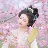 春风拂柳绿如烟，执伞漫步花树下